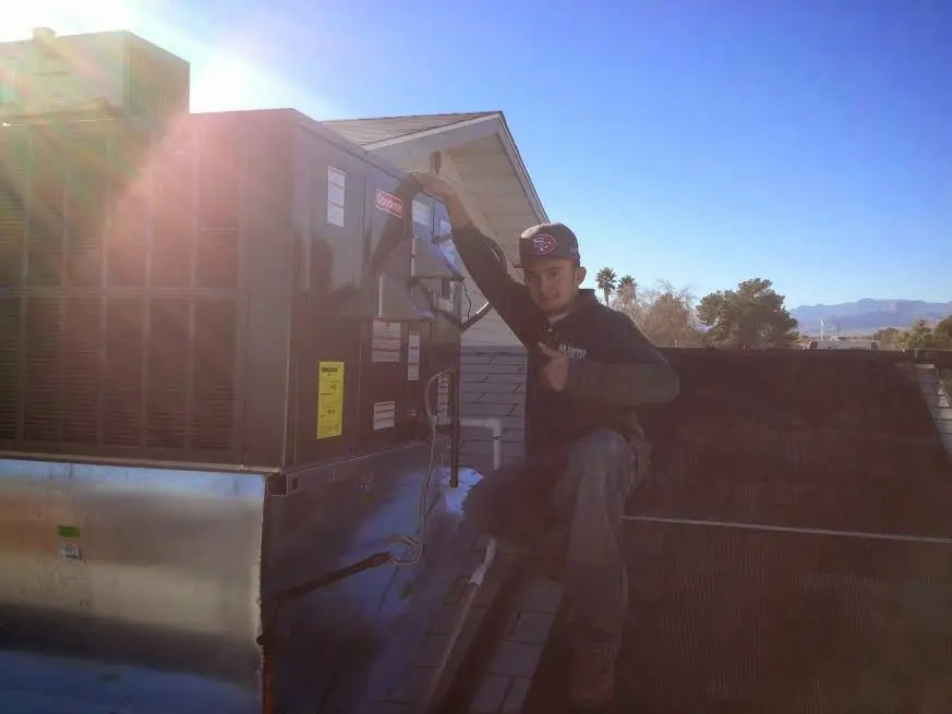 HVAC technician performing Air Duct Repair on a rooftop unit in Imperial Beach